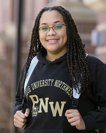 A PNW student in a Purdue Northwest hoodie on campus