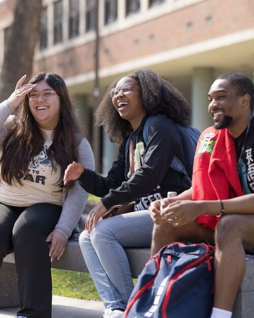 PNW students sit outdoors on campus