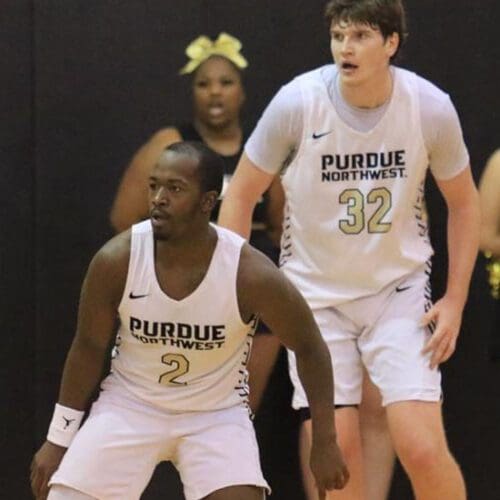 Two Purdue University basketball players in the middle of a game.