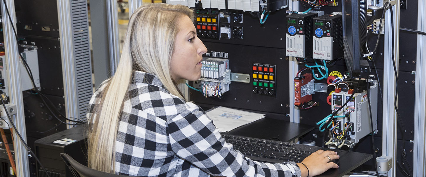 A PNW student works with electronic equipment