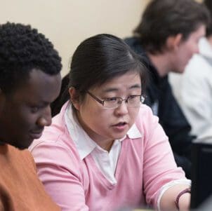 Colleagues collaborate at a computer