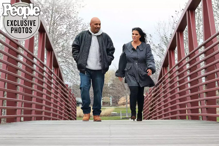 Nicky Jackson and Willie Donald walk across a bridge together.