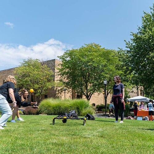 Students playing bean-bag toss