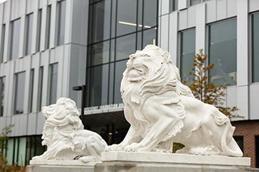 Two lion statues are pictured at the entrance of the NILS building on the Hammond campus
