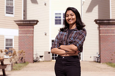 A female student stands outside PNW housing