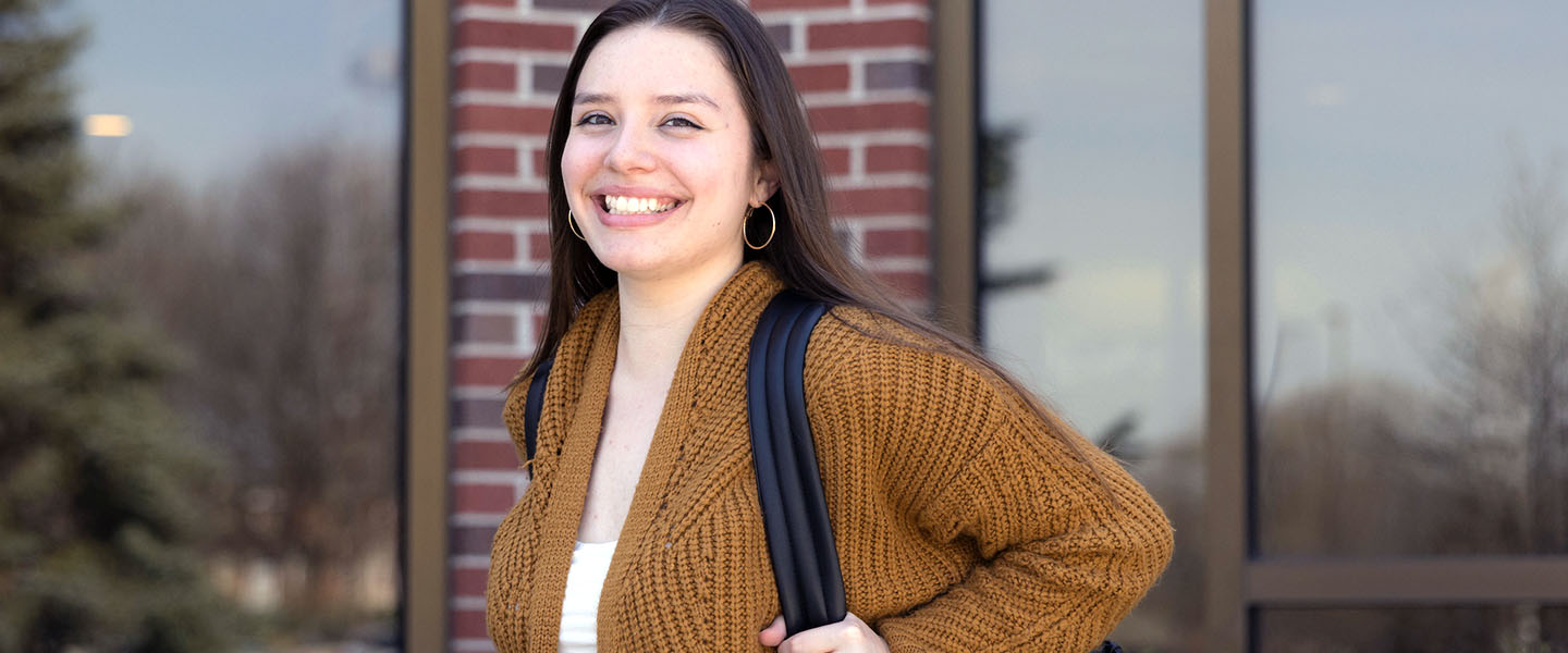 A PNW student poses outdoors on campus