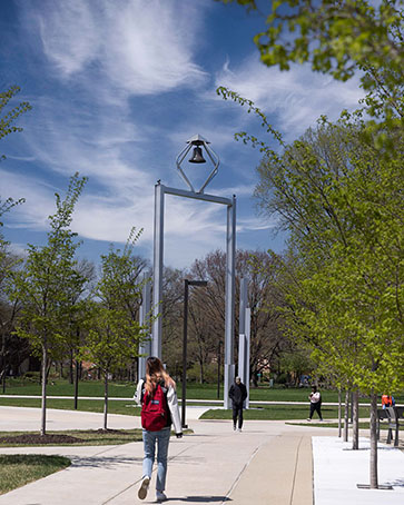 Students walk by the PNW Bell Tower