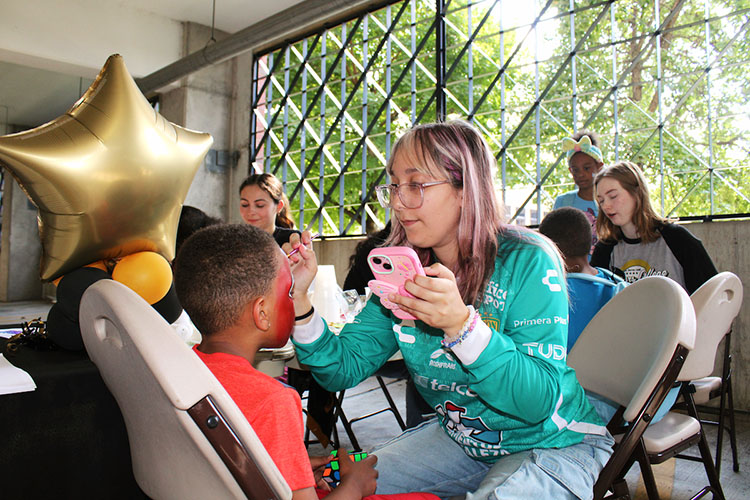 Children get their faces painted.