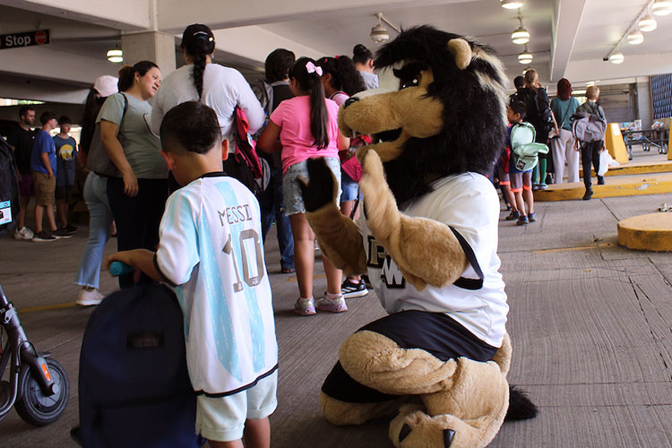 PNW mascot Leo gives a student a high-five