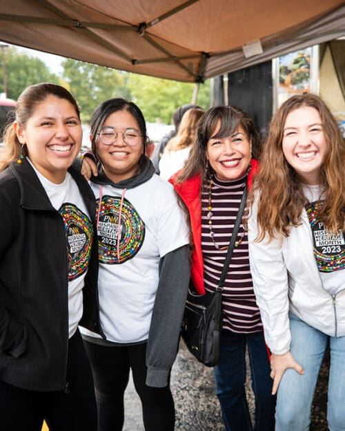 Four people pose together during a Hispanic Heritage Month Festival