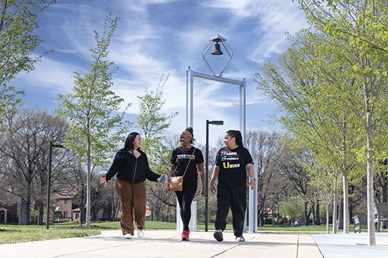 PNW students walk in front of the Bell Tower