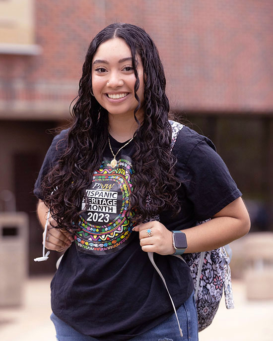 A PNW student in a Hispanic Heritage Month t-shirt outdoors