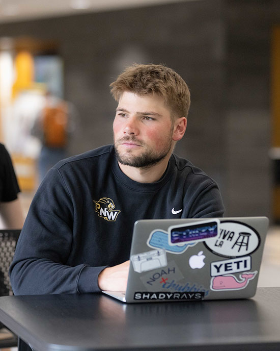 A PNW student works on a laptop