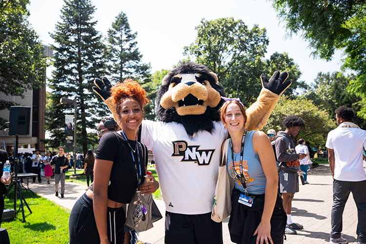 Two students pose with Leo the Lion