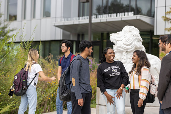 PNW students talk together in front of the Nils K. Nelson Bioscience Innovation Building