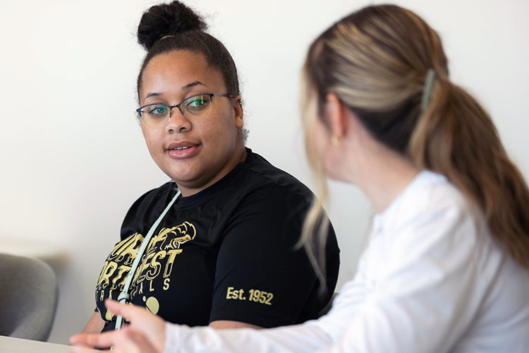 PNW students talk in a classroom