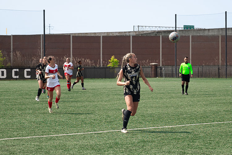 PNW women's soccer players run down the field