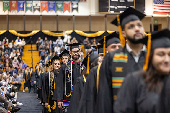 Nursing students line up in a commencement procession