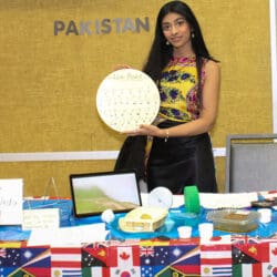 A student stands at a Pakistan table during Global Groove