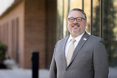 PNW Chancellor Holford outside the Nils K. Nelson Bioscience Innovation Building.