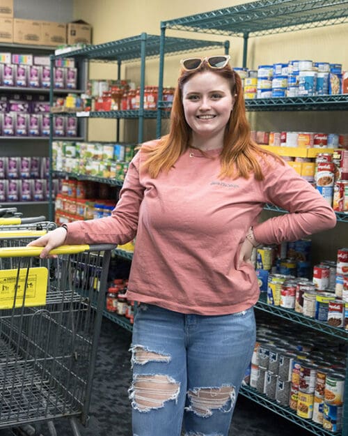 A student stands in the PNW food pantry