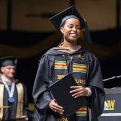 A PNW student crosses the stage with her degree