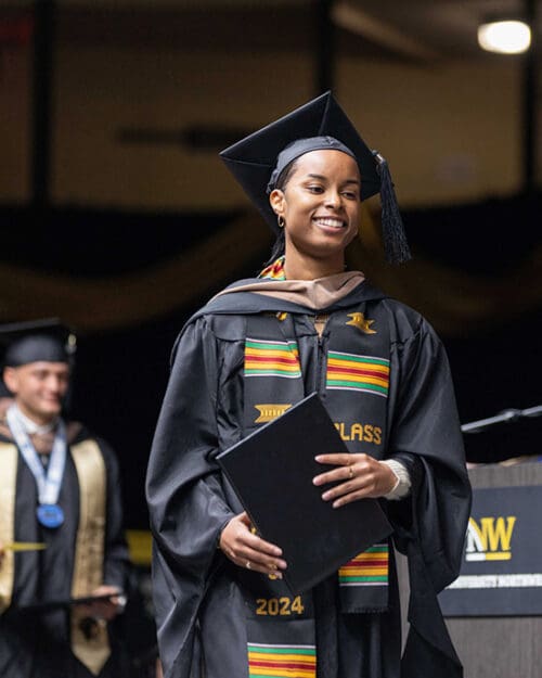 A PNW student crosses the stage with her degree