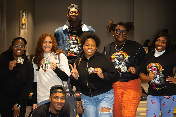 Seven students stand together during a Black History Month celebration