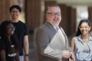 PNW Chancellor Holford laughs with students outside