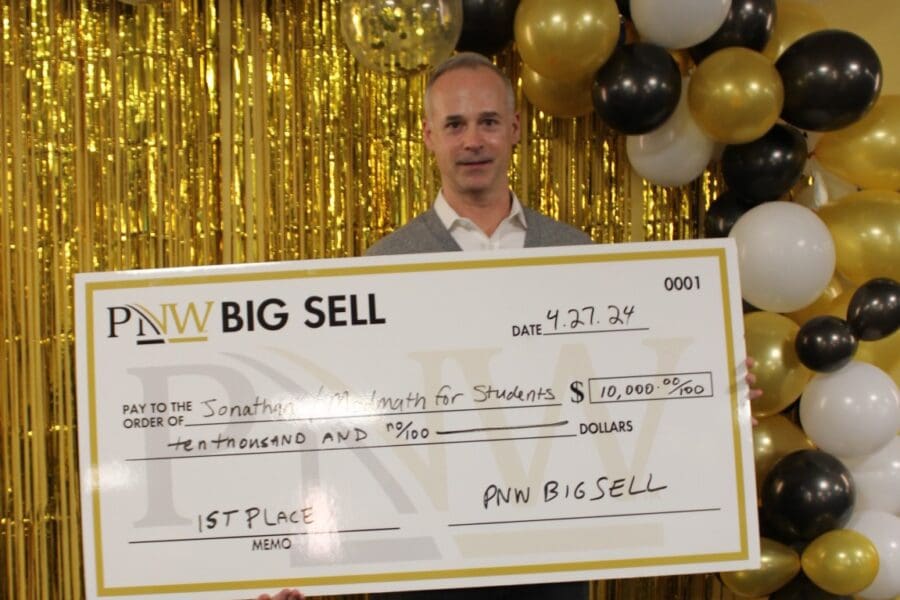 First Place winner Jonathan Rose with large prize check for $10,000 dollars