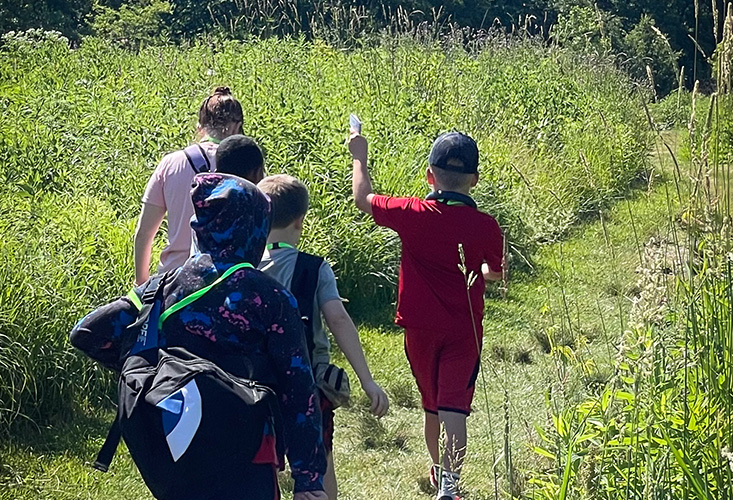 Kids walking along a trail at Gabis Arboretum.