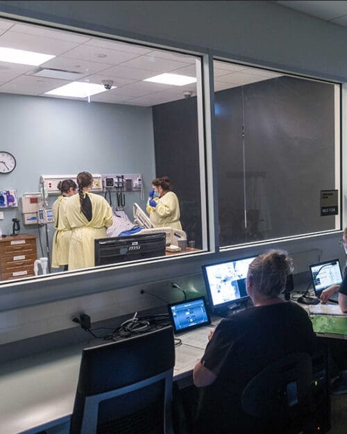 Students work in a nursing simulation lab