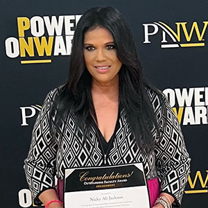 PNW professor Nicky Jackson poses with an award at Founders Day