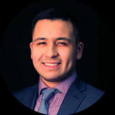 Professional headshot of Marcelino Valdez in suit and tie