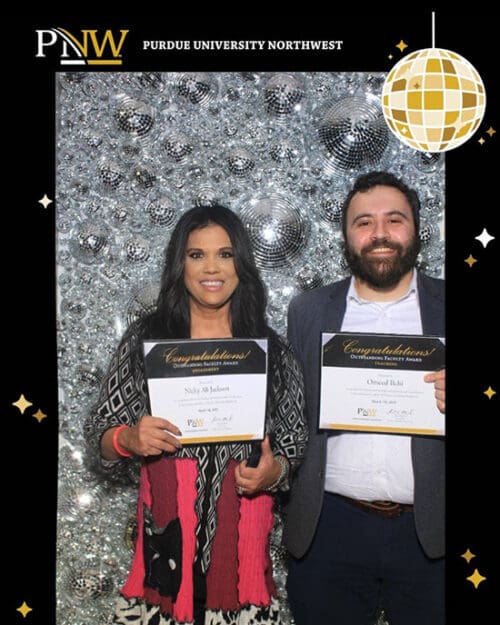 PNW professors Nicky Jackson and Omeed Ilchi display their outstanding faculty awards from Founders Day 2025.